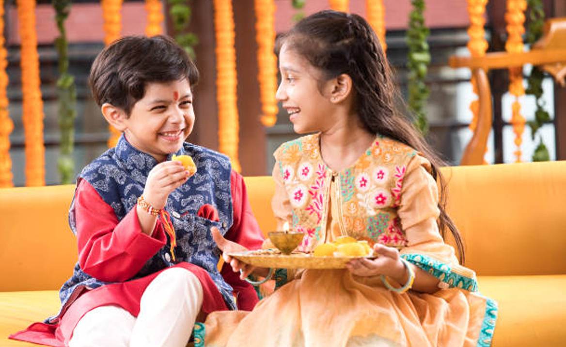 "Brother and sister performing Bhau Beej ceremony with a traditional aarti thali, where the sister applies a tilak on her brother's forehead and offers prayers for his well-being."