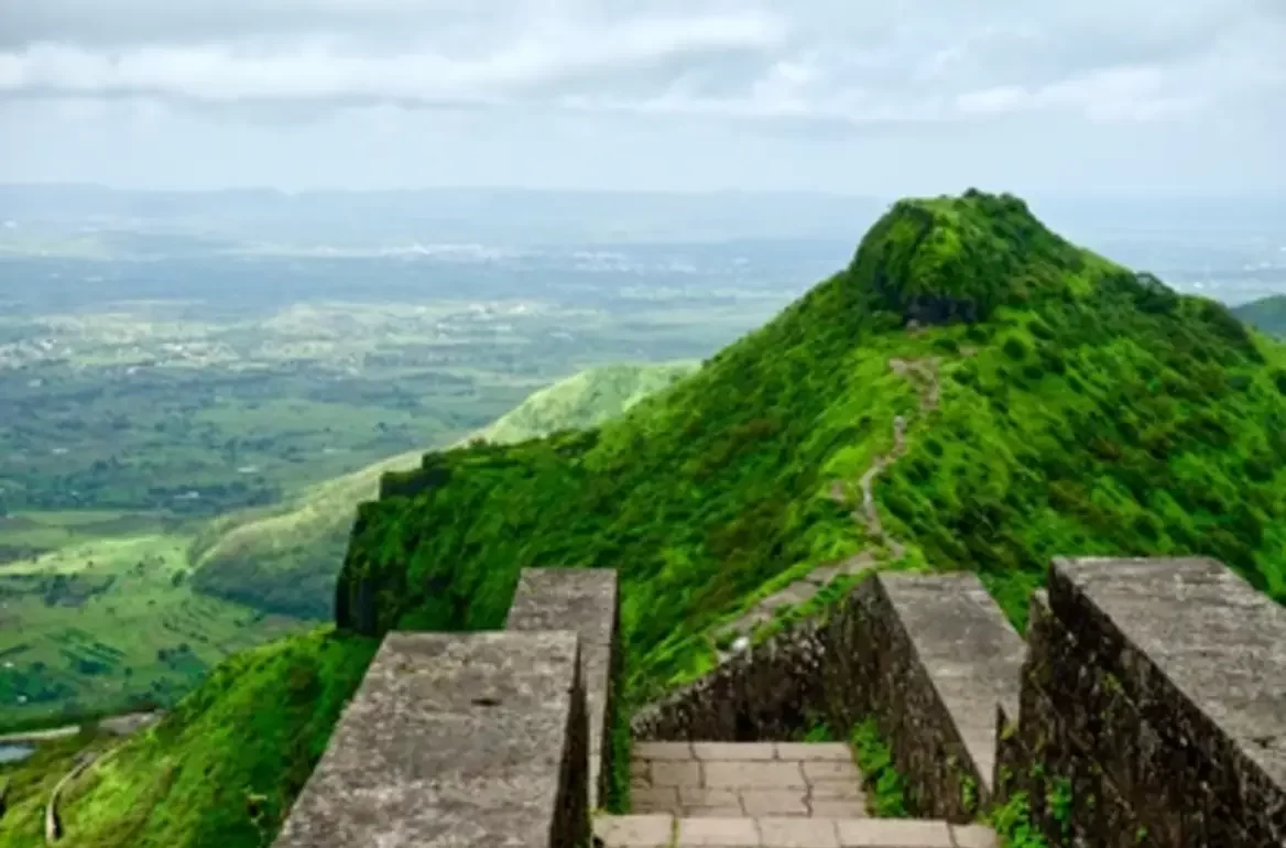 "Purandar Fort: Majestic hill fort offering panoramic views of the surrounding landscape and showcasing historical architecture."